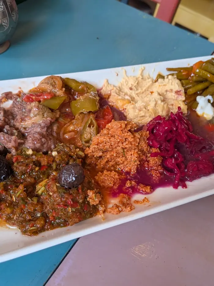 Long meze platter — olives, ezme, bulgur, beetroot and yoghurt dishes